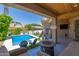 Inviting backyard with a pool, covered patio, and lush landscaping at 2634 E Tamarisk St, Gilbert, AZ 85296