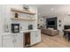 Convenient bar area with beverage fridge and floating shelves, adjacent to living and dining area at 2634 E Tamarisk St, Gilbert, AZ 85296