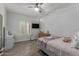 Inviting bedroom featuring a ceiling fan, wood-look floors, and natural light from the window at 2634 E Tamarisk St, Gilbert, AZ 85296
