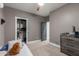 Comfortable bedroom with a ceiling fan, closet, and dresser, perfect for relaxation and storage at 2634 E Tamarisk St, Gilbert, AZ 85296