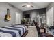 Cozy bedroom with a city-themed accent wall, comfortable bed, and modern ceiling fan at 2634 E Tamarisk St, Gilbert, AZ 85296