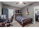 Stylish bedroom with a ceiling fan, sports memorabilia, and an organized closet space at 2634 E Tamarisk St, Gilbert, AZ 85296