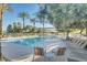 Relaxing community pool area with lounge chairs and palm trees, ideal for residents' enjoyment at 2634 E Tamarisk St, Gilbert, AZ 85296