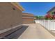 Spacious driveway leading to a two-car garage, with a side yard and white fence at 2634 E Tamarisk St, Gilbert, AZ 85296