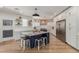 Bright, open kitchen featuring white cabinetry, large island with seating, and stainless steel appliances at 2634 E Tamarisk St, Gilbert, AZ 85296