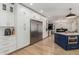 Open concept kitchen with stainless steel appliances, white cabinets and a blue island with seating at 2634 E Tamarisk St, Gilbert, AZ 85296