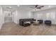 Open concept living room with a sectional sofa and view of the staircase at 2634 E Tamarisk St, Gilbert, AZ 85296