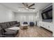 Spacious living room featuring a large sectional sofa and modern ceiling fan at 2634 E Tamarisk St, Gilbert, AZ 85296