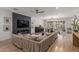 Spacious living room with fireplace, large sectional, and dining area with modern chandelier at 2634 E Tamarisk St, Gilbert, AZ 85296