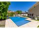 Refreshing backyard pool with stone coping, perfect for relaxation and recreation at 2634 E Tamarisk St, Gilbert, AZ 85296