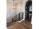 Modern staircase with wood steps, metal railing, and stylish light fixture at 2707 E James St, Gilbert, AZ 85296