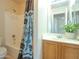 A compact bathroom featuring a shower-tub combination and a vanity with a plant accent at 2826 E Tracy Ln # 3, Phoenix, AZ 85032
