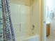 Bright bathroom features a tiled shower-tub with a new shower head and curtain at 2826 E Tracy Ln # 3, Phoenix, AZ 85032