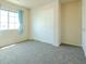 A spacious bedroom with carpet flooring, a window and a closet at 2826 E Tracy Ln # 3, Phoenix, AZ 85032