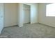 A spacious bedroom with carpet flooring, a window and a closet at 2826 E Tracy Ln # 3, Phoenix, AZ 85032