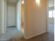A cozy hallway featuring neutral-colored walls, plush carpeting, and doors leading to various rooms at 2826 E Tracy Ln # 3, Phoenix, AZ 85032