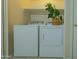 Laundry closet featuring a modern washer and dryer with a shelf above for storage at 2826 E Tracy Ln # 3, Phoenix, AZ 85032
