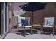 Inviting patio area with comfortable chairs, accent table, and ambient string lights at 2826 E Tracy Ln # 3, Phoenix, AZ 85032