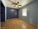 Bedroom with blue accent wall, light grey wall, and window at 3738 W Danbury Dr, Glendale, AZ 85308