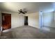 Neutral bedroom featuring a ceiling fan, carpet flooring, and multiple doors and closet at 3738 W Danbury Dr, Glendale, AZ 85308