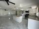Spacious kitchen with an island, stainless steel appliances, and white cabinetry and access to living area at 3738 W Danbury Dr, Glendale, AZ 85308