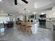 The kitchen features white cabinets, stainless steel appliances, an island, and adjoins the laundry room at 3738 W Danbury Dr, Glendale, AZ 85308