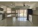 Open kitchen with island, stainless appliances, tile flooring and sliding glass door to the backyard at 3738 W Danbury Dr, Glendale, AZ 85308