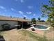 Backyard view featuring a refreshing pool, patio area, and lush foliage under a clear sky at 3738 W Danbury Dr, Glendale, AZ 85308