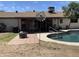 The pool is surrounded by a brick patio, and there is an outdoor grilling area under a covered patio at 3738 W Danbury Dr, Glendale, AZ 85308