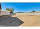Expansive dirt backyard surrounded by a block fence, providing seclusion at 3840 W Abraham Ln, Glendale, AZ 85308