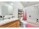Bathroom with a shower-tub combo, shelving, and vanity at 3840 W Abraham Ln, Glendale, AZ 85308
