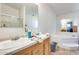 Bathroom boasts dual sinks, large mirror, shower and soaking tub at 3840 W Abraham Ln, Glendale, AZ 85308