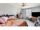 Cozy bedroom with a ceiling fan, window, and soft pastel decor at 3840 W Abraham Ln, Glendale, AZ 85308
