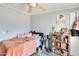 Bright bedroom features neutral walls, ceiling fan, and a comfortable bed with soft lighting at 3840 W Abraham Ln, Glendale, AZ 85308