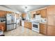 Functional kitchen with appliances and wood cabinets at 3840 W Abraham Ln, Glendale, AZ 85308