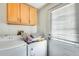 Bright laundry room with washer, dryer, and storage cabinets at 3840 W Abraham Ln, Glendale, AZ 85308