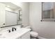 Bathroom featuring a mirror, a bright window, toilet, and quartz countertop at 40470 W Agave Rd, Maricopa, AZ 85138
