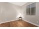 Bedroom featuring hardwood floors, a window, and neutral paint at 40470 W Agave Rd, Maricopa, AZ 85138