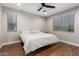 Serene bedroom with wood floors, neutral walls, and a ceiling fan at 40470 W Agave Rd, Maricopa, AZ 85138