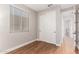 Bedroom featuring hardwood floors, a bright window, and neutral paint at 40470 W Agave Rd, Maricopa, AZ 85138