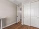 Bedroom with closet doors, wood floor and neutral wall at 40470 W Agave Rd, Maricopa, AZ 85138