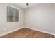Cozy bedroom featuring hardwood floors, bright window, and neutral paint at 40470 W Agave Rd, Maricopa, AZ 85138
