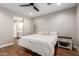 Cozy bedroom with wood floors, a view into the bathroom, and side table at 40470 W Agave Rd, Maricopa, AZ 85138