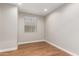 Well lit bedroom featuring a window and wood flooring at 40470 W Agave Rd, Maricopa, AZ 85138