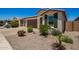 Charming home with desert landscaping, three car garage and dark green shutters at 40470 W Agave Rd, Maricopa, AZ 85138