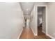 Long hallway with wood floors and white trim leading to other rooms at 40470 W Agave Rd, Maricopa, AZ 85138