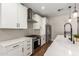 Bright kitchen with stainless steel appliances, subway tile backsplash, and a large center island at 40470 W Agave Rd, Maricopa, AZ 85138