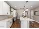 Well-equipped kitchen featuring stainless steel appliances, white cabinets, and ample countertop space at 40470 W Agave Rd, Maricopa, AZ 85138
