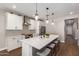 Modern kitchen with white cabinetry, stainless steel appliances, and a large center island with seating at 40470 W Agave Rd, Maricopa, AZ 85138