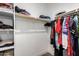 Walk-in closet with built-in shelving and rods providing organized storage solutions at 40470 W Agave Rd, Maricopa, AZ 85138